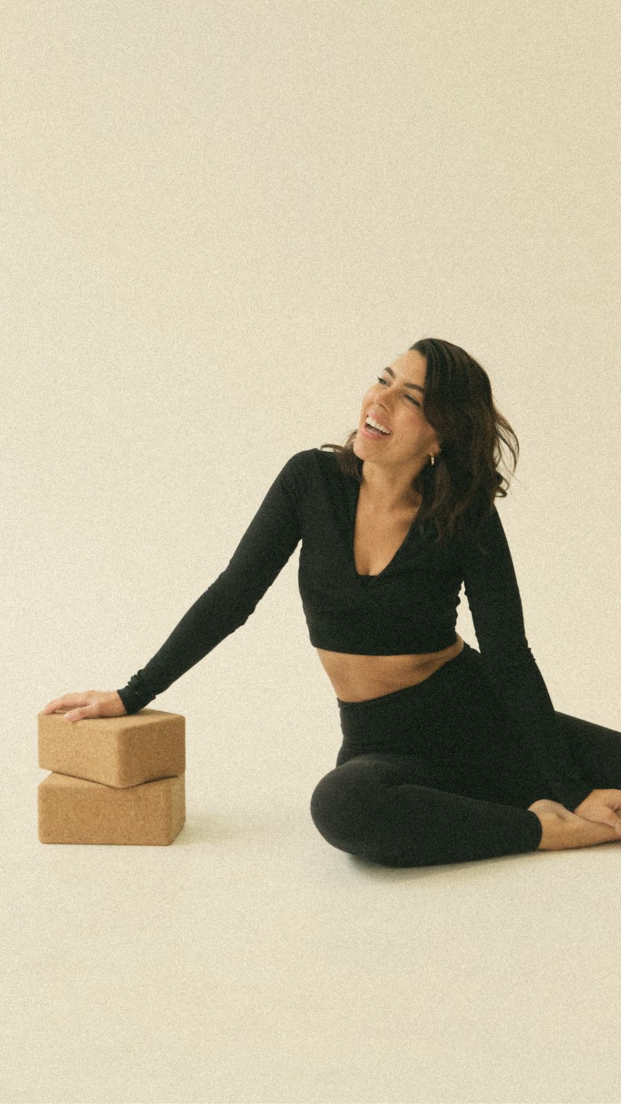 Melo laughing beside cork yoga blocks