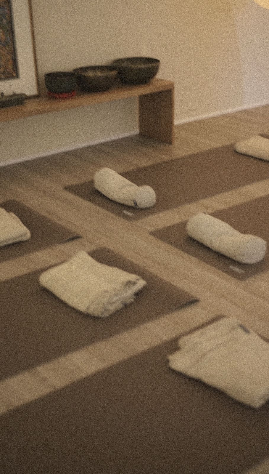 Warm yoga studio set with mats, blankets and singing bowls